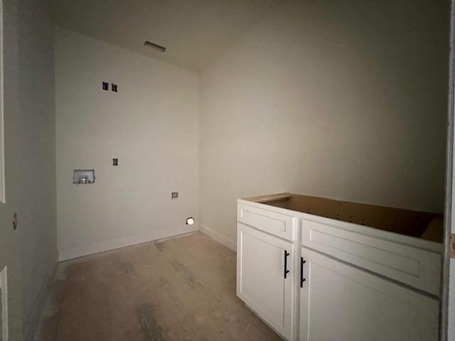 laundry room featuring hookup for a washing machine, cabinet space, and baseboards