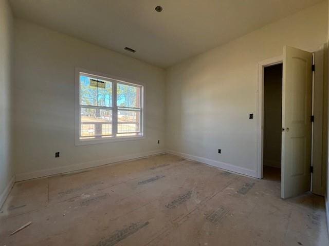 unfurnished room featuring baseboards