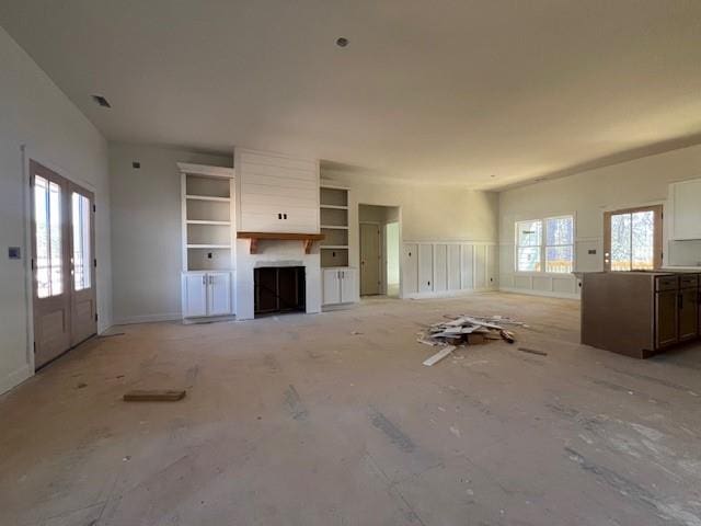 unfurnished living room with visible vents and plenty of natural light