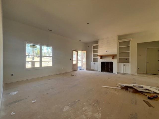 unfurnished living room featuring a fireplace and baseboards