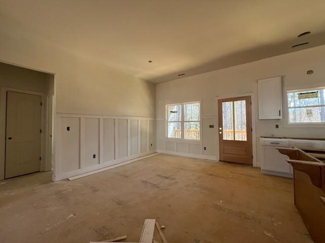 unfurnished living room with a decorative wall