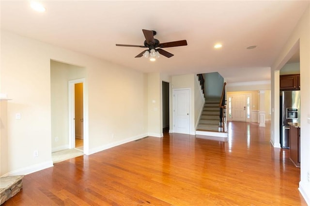 unfurnished living room with ceiling fan and light hardwood / wood-style flooring