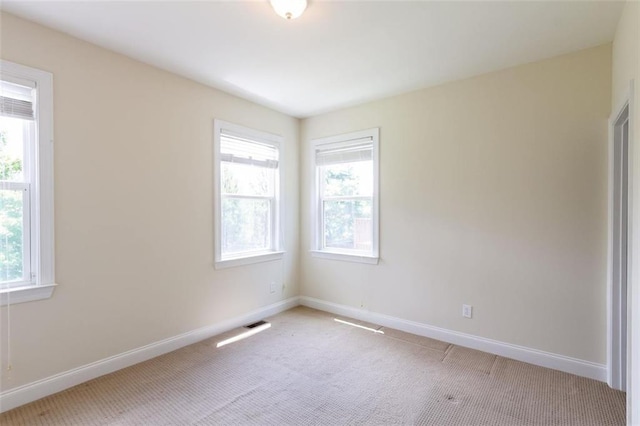 unfurnished room with light colored carpet