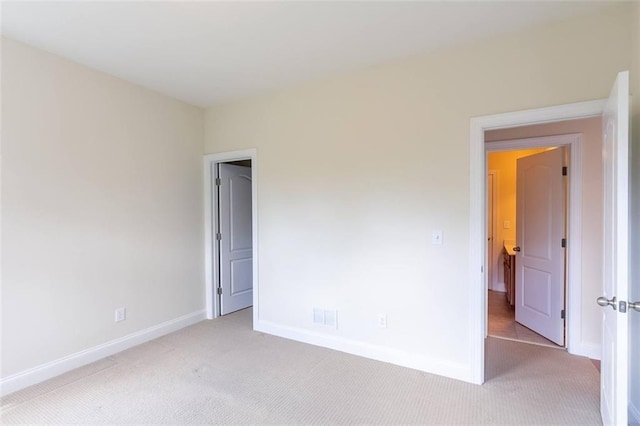 empty room featuring light colored carpet