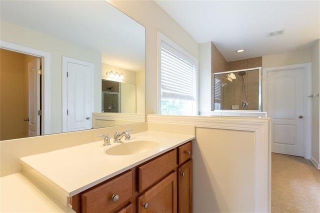 bathroom featuring vanity and a shower with shower door