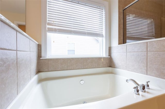 bathroom with a tub to relax in