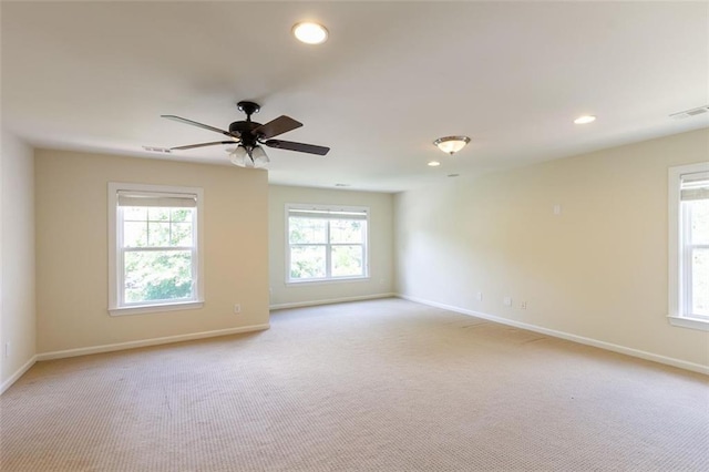 unfurnished room with ceiling fan and light carpet