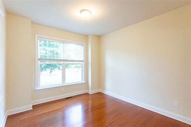 empty room with wood-type flooring