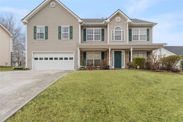 view of front facade with a garage, a front yard, covered porch, and driveway