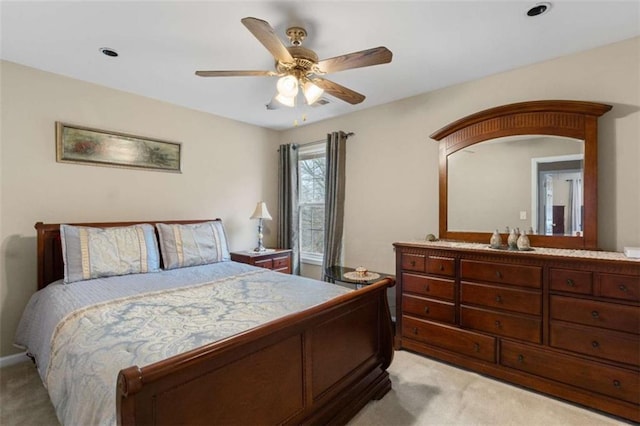 bedroom featuring light carpet and a ceiling fan