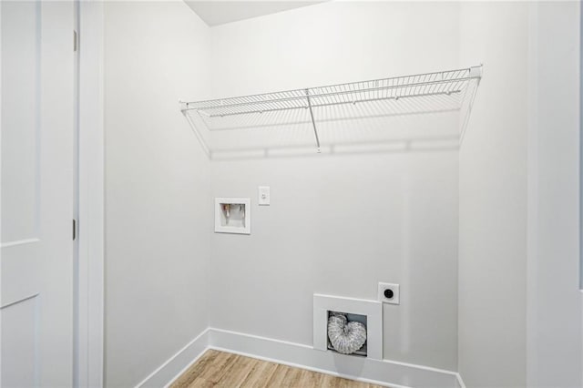 laundry area featuring hookup for a washing machine, laundry area, wood finished floors, baseboards, and electric dryer hookup