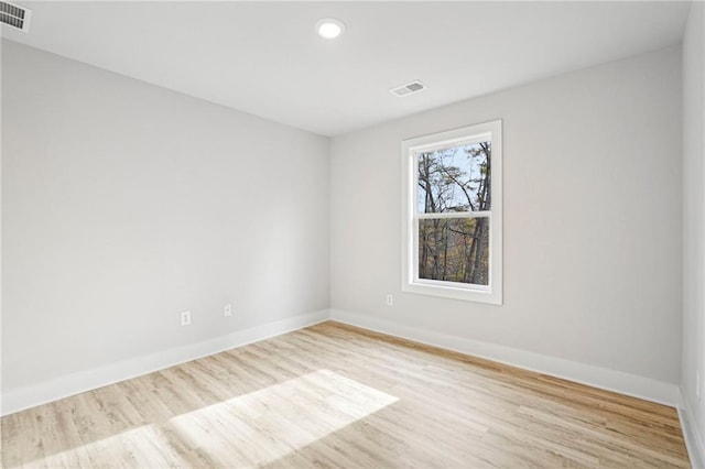 empty room with visible vents, baseboards, wood finished floors, and recessed lighting