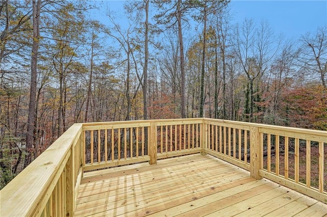 wooden deck with a view of trees