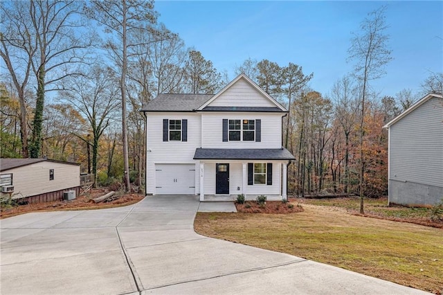 view of front of home featuring driveway, a front lawn, and an attached garage