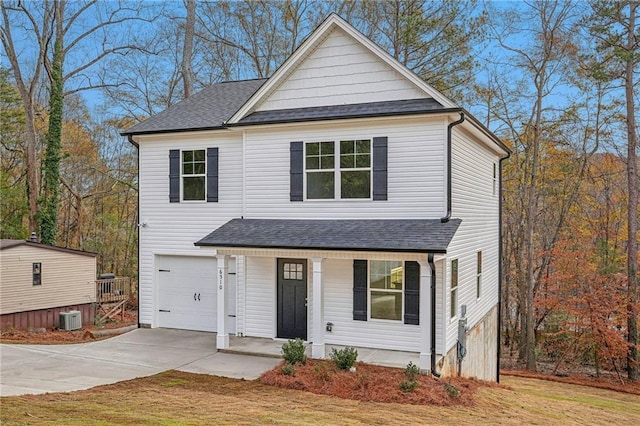 view of front of property featuring concrete driveway, roof with shingles, an attached garage, covered porch, and central AC