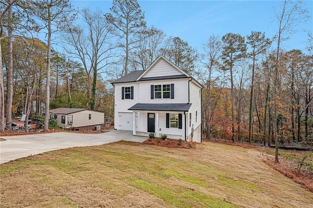 view of front of home with driveway, an attached garage, and a front lawn