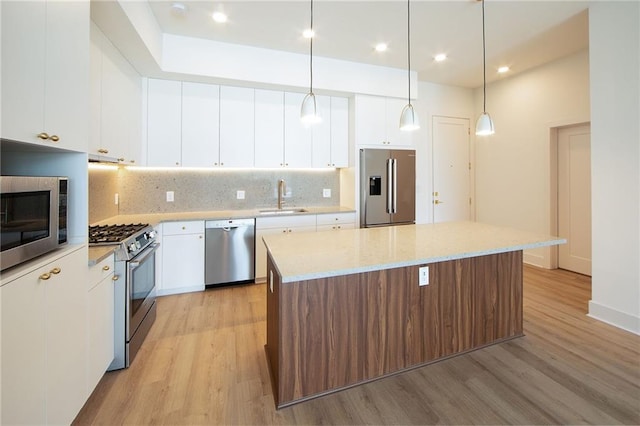 675 Drewry St NE Unit 205, Atlanta, GA 30306 - kitchen with appliances with stainless steel finishes, a sink, light wood-style flooring, a kitchen island, and recessed lighting