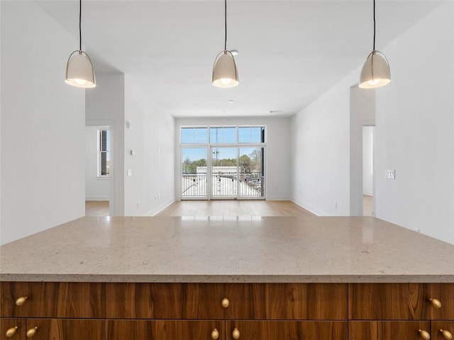 675 Drewry St NE Unit 205, Atlanta, GA 30306 - kitchen featuring open floor plan, hanging light fixtures, and light stone countertops