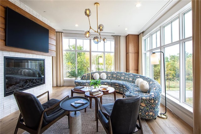675 Drewry St NE Unit 205, Atlanta, GA 30306 - living room with ornamental molding, wood finished floors, a chandelier, and a large fireplace