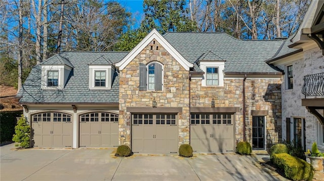 french country style house featuring a garage