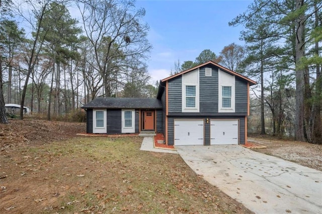 tri-level home featuring a front yard and a garage