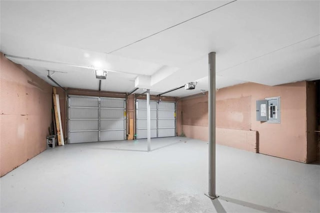 garage with electric panel and a garage door opener