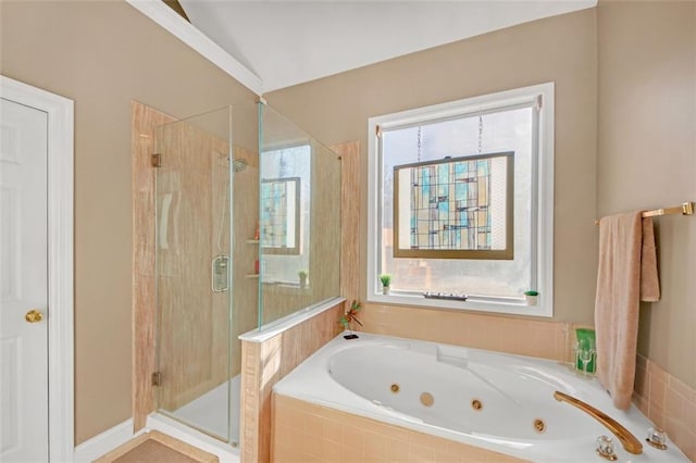 full bathroom with plenty of natural light, a shower stall, and a tub with jets