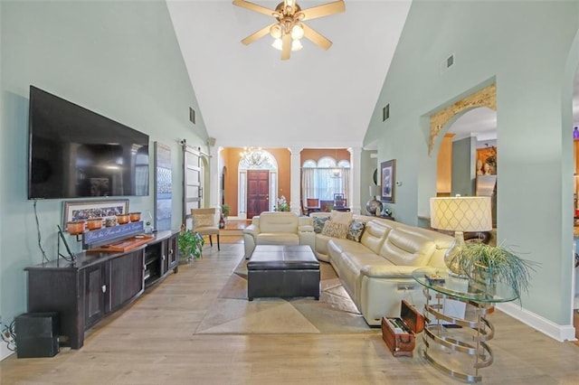 living area featuring ornate columns, ceiling fan, visible vents, and light wood-style floors