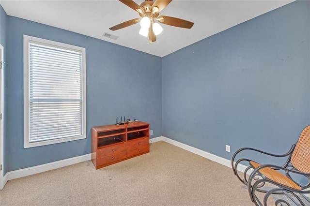 living area with carpet floors, baseboards, visible vents, and a ceiling fan