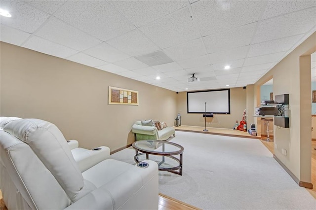 cinema room with recessed lighting, a paneled ceiling, and baseboards