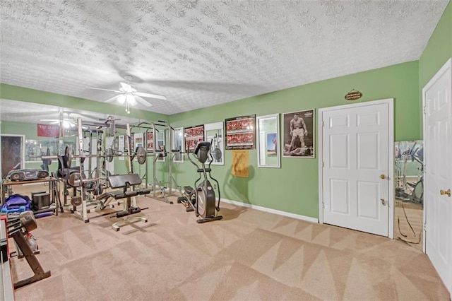 gym featuring carpet floors, ceiling fan, and a textured ceiling