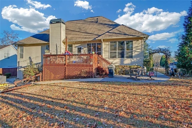 back of house with a patio, a chimney, and a wooden deck