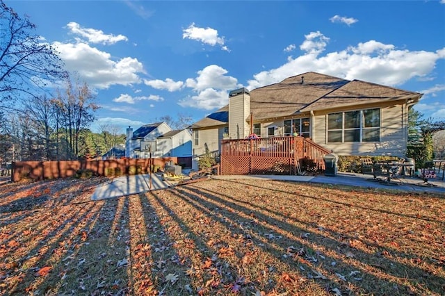 rear view of property featuring a deck