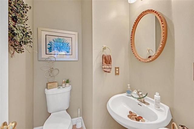 half bathroom with a sink and toilet