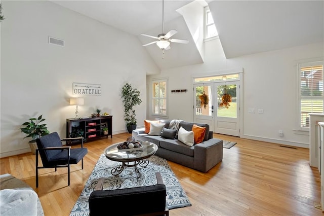 living room with french doors, ceiling fan, light hardwood / wood-style flooring, and high vaulted ceiling