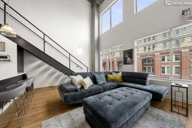 living room featuring hardwood / wood-style flooring and a high ceiling