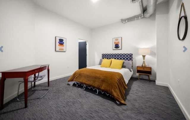 bedroom with dark colored carpet