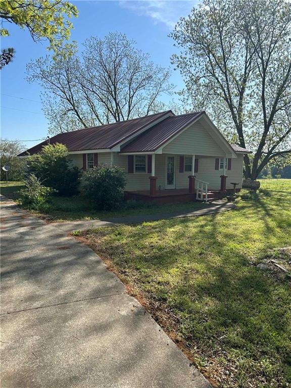 2110 Brindle Farmer Rd, Good Hope, GA 30641 - view of front facade with a front lawn, a metal roof, and a porch