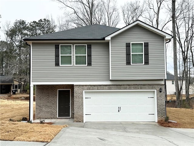 view of front facade featuring concrete driveway, an attached garage, and brick siding