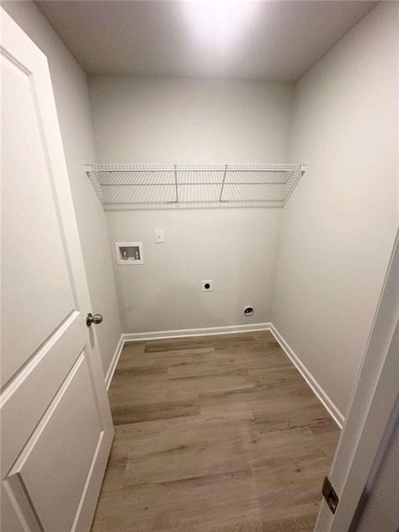 laundry room with baseboards, washer hookup, laundry area, wood finished floors, and electric dryer hookup