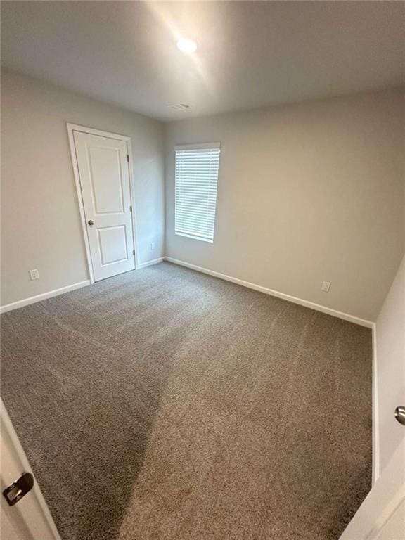 empty room with baseboards and carpet floors