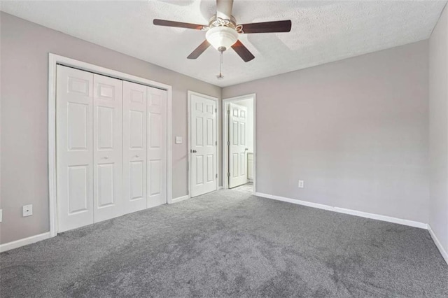 unfurnished bedroom featuring a textured ceiling, ceiling fan, and dark colored carpet