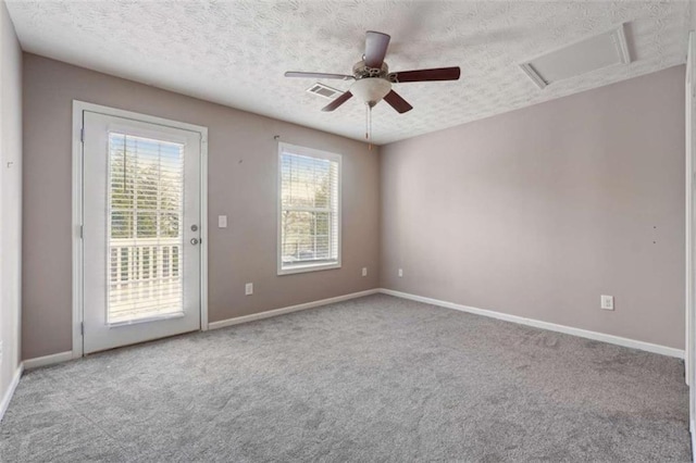 carpeted empty room with a textured ceiling and ceiling fan