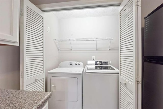 clothes washing area featuring washing machine and dryer