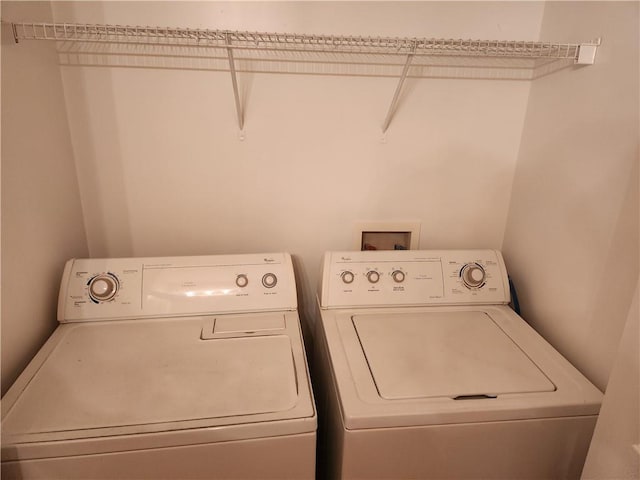 clothes washing area with laundry area and separate washer and dryer