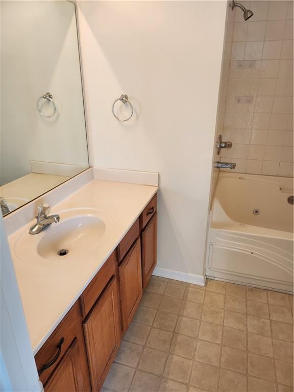 bathroom featuring bathtub / shower combination, vanity, and baseboards