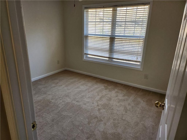 empty room with carpet floors and baseboards