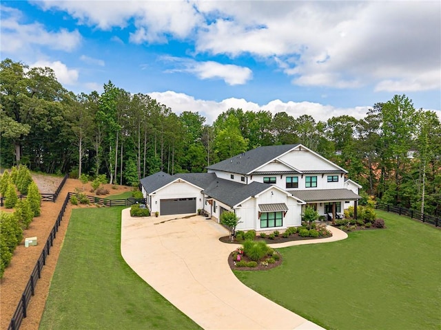 6301 New Bethany Rd, Buford, GA 30518 - modern inspired farmhouse featuring board and batten siding, an attached garage, concrete driveway, roof with shingles, and a forest view