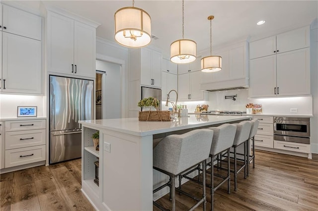 6301 New Bethany Rd, Buford, GA 30518 - kitchen with stainless steel refrigerator, light countertops, white cabinetry, an island with sink, and dark wood finished floors