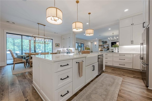 6301 New Bethany Rd, Buford, GA 30518 - kitchen featuring ornamental molding, appliances with stainless steel finishes, dark wood finished floors, light countertops, and white cabinetry